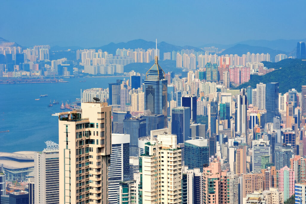 Hong Kong aerial view panorama with urban skyscrapers and sea.